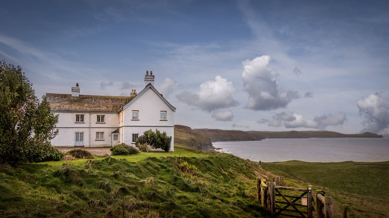 The exterior of Doyden House, home to Carnweather, Mouls, Rumps and Conor holiday apartments, with sea views over Lundy Bay, Cornwall